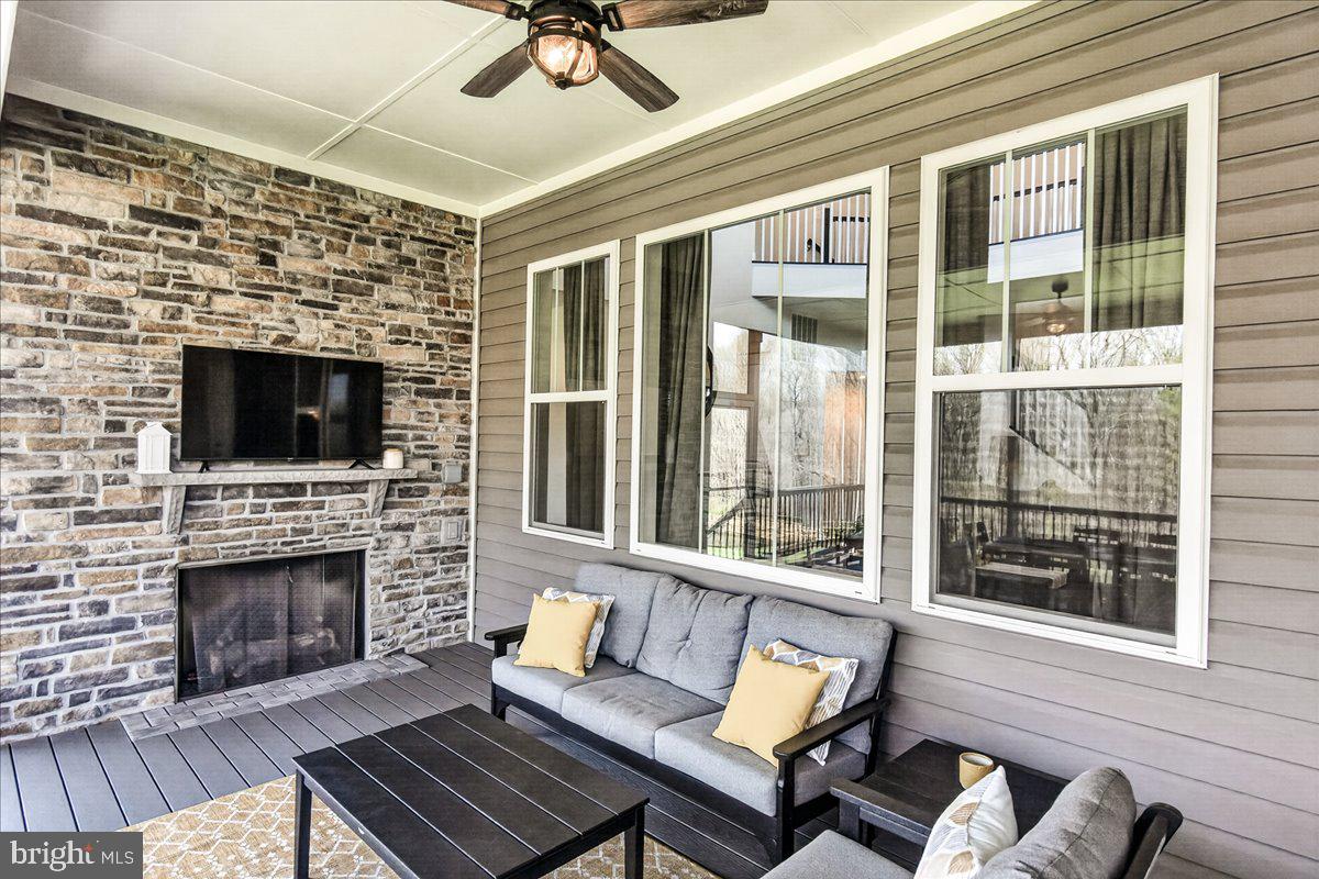 3633 Moline Court Monrovia, MD 21770 - Photo 39 of 82 a living room with furniture a flat screen tv and a fireplace
