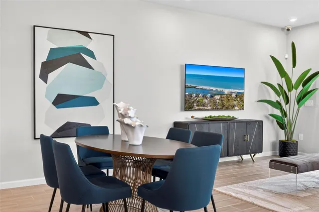 a dining room with furniture and wooden floor
