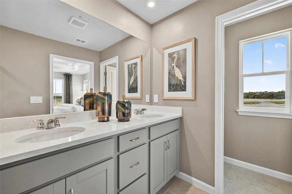 8830 Ginko Run Parrish, FL 34219 - Photo 22 of 29 a en suite bathroom with double sink and a mirror