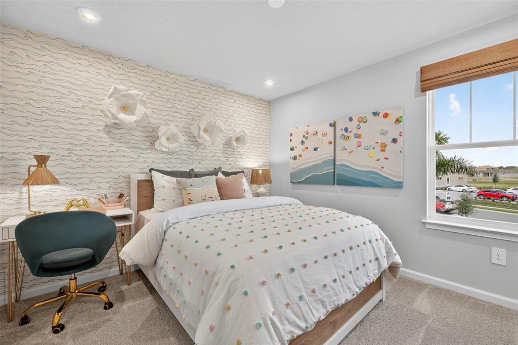 8830 Ginko Run Parrish, FL 34219 - Photo 24 of 29 a bedroom with a bed a dresser and chair