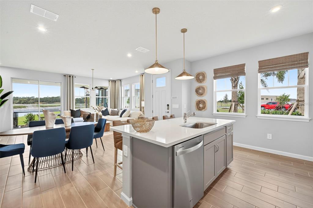 8830 Ginko Run Parrish, FL 34219 - Photo 9 of 29 a room with furniture a large window and a chandelier