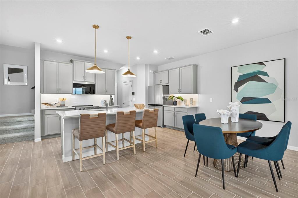 8830 Ginko Run Parrish, FL 34219 - Photo 10 of 29 a large kitchen with a table and chairs