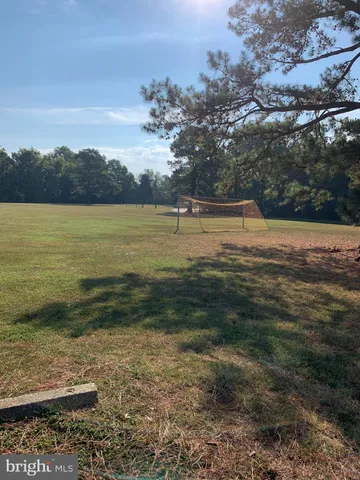 a view of a backyard with outdoor seating