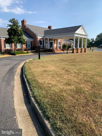a view of water heater room with wooden floor