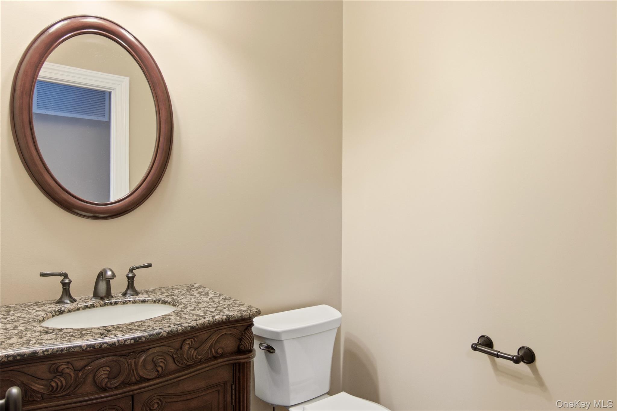 69 Old Depot Road Quogue, NY 11959 - Photo 15 of 40 Half bath with vanity and toilet