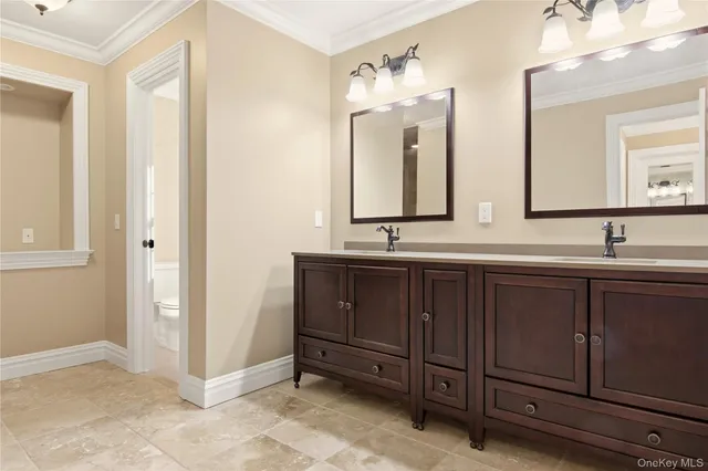a bathroom with a double vanity sink and a mirror