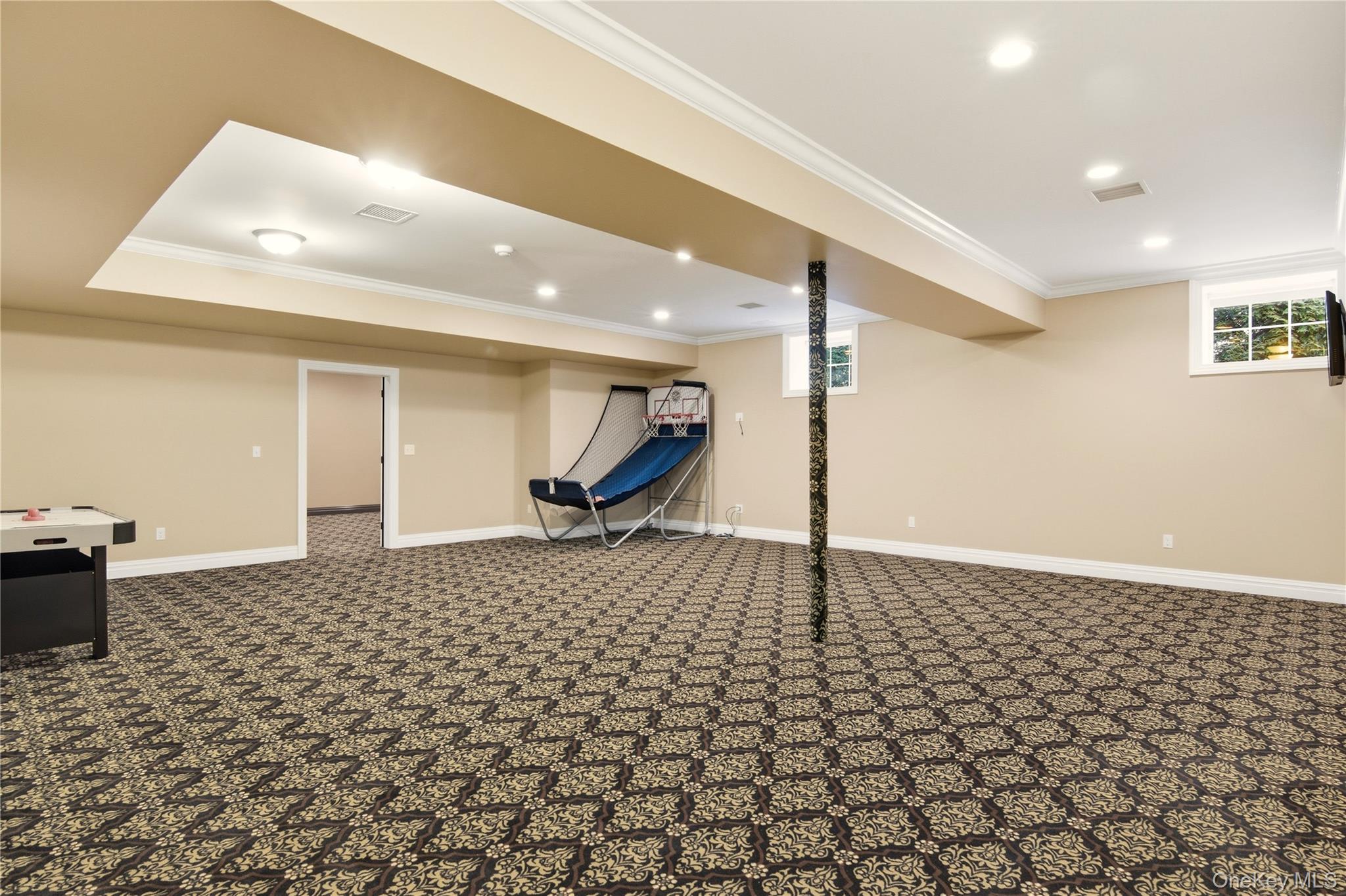 69 Old Depot Road Quogue, NY 11959 - Photo 33 of 40 Below grade area featuring crown molding, carpet, recessed lighting, and plenty of natural light