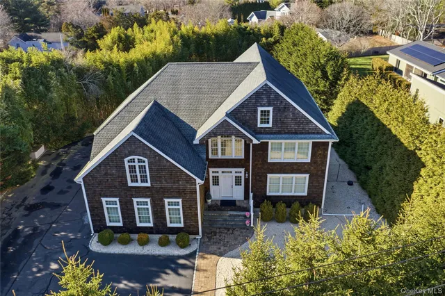 a front view of a house with yard and green space