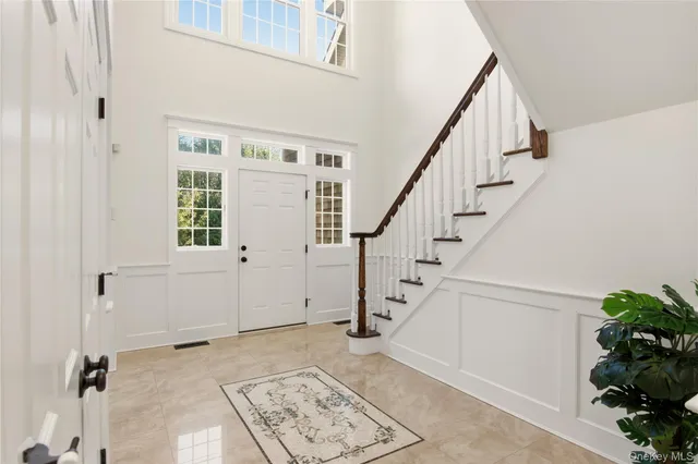 a view of entryway with a window and stairs