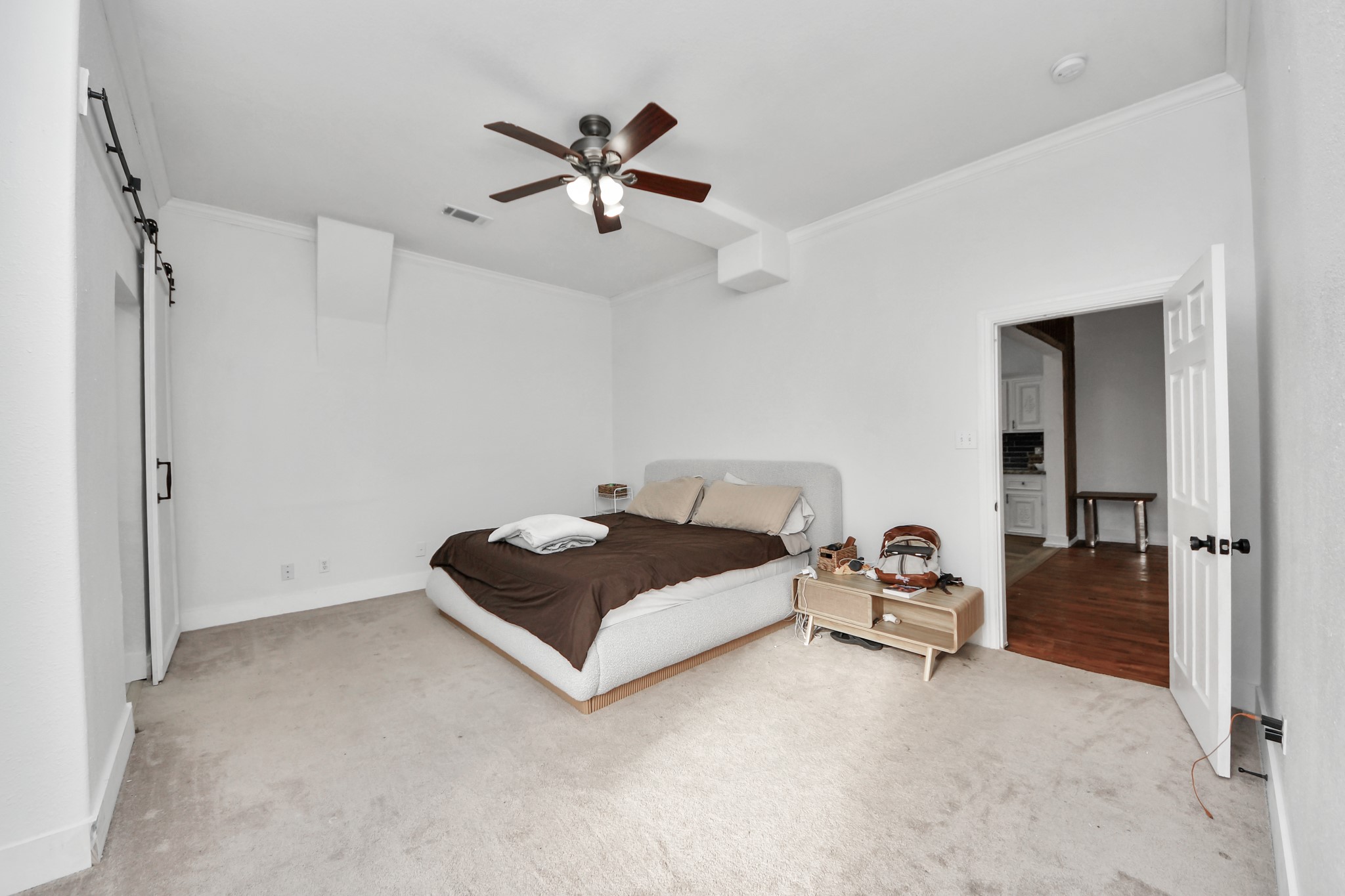 6833 Stonehaven Way Houston, TX 77085 - Photo 11 of 23 a spacious bedroom with a bed and a chandelier