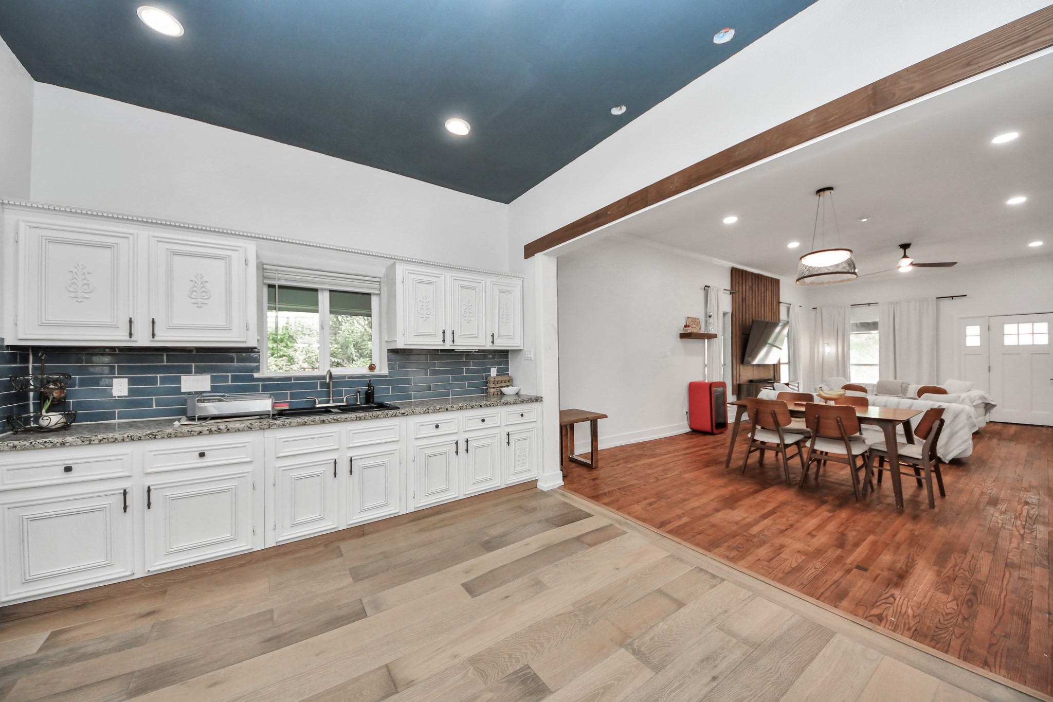 6833 Stonehaven Way Houston, TX 77085 - Photo 5 of 23 a large white kitchen with lots of counter space and dining table