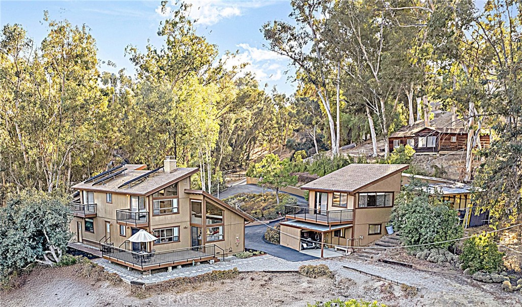 an aerial view of a house with a big yard
