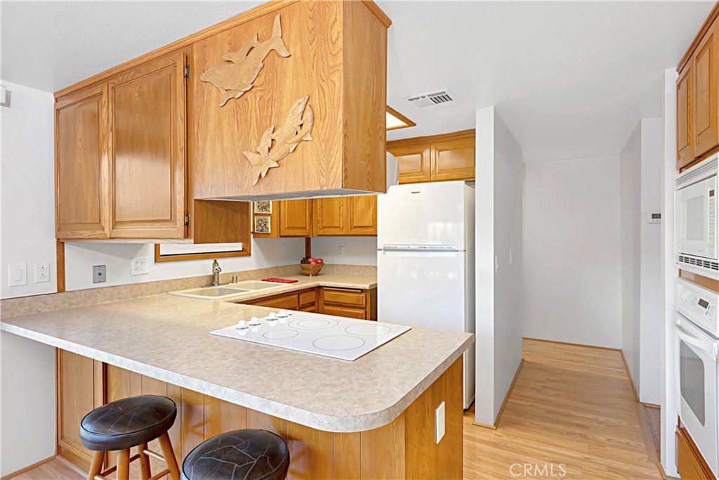 11879 Rocoso Road Lakeside, CA 92040 - Photo 11 of 25 a kitchen with a sink a stove and a refrigerator