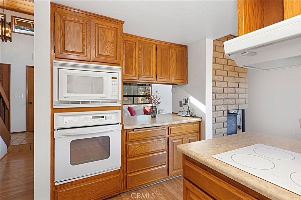 11879 Rocoso Road Lakeside, CA 92040 - Photo 12 of 25 a kitchen with stainless steel appliances a stove microwave and cabinets