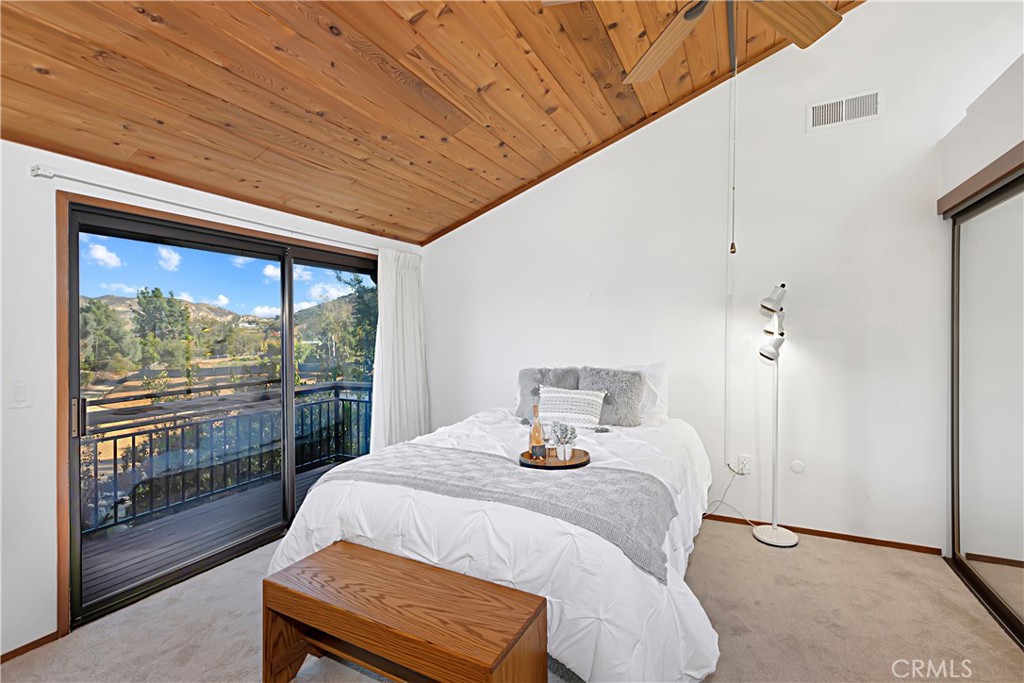 11879 Rocoso Road Lakeside, CA 92040 - Photo 15 of 25 a bedroom with a bed and wooden floor