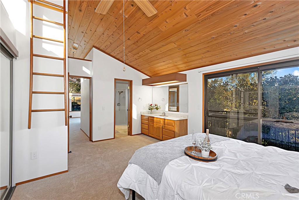 11879 Rocoso Road Lakeside, CA 92040 - Photo 16 of 25 a bedroom with furniture and a large window