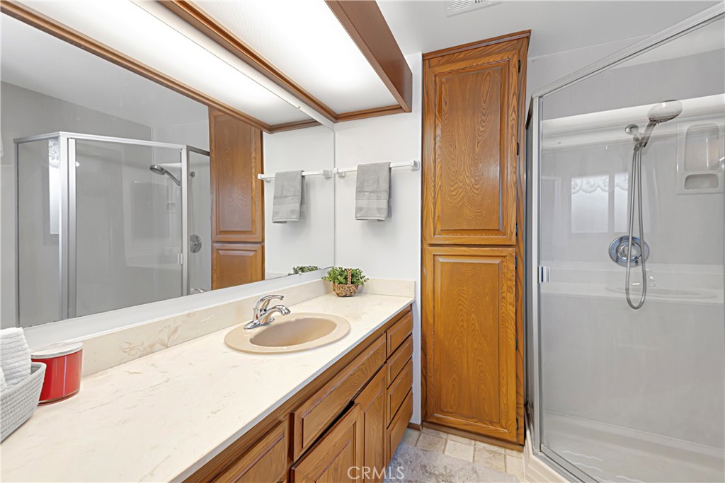 11879 Rocoso Road Lakeside, CA 92040 - Photo 17 of 25 a bathroom with a sink vanity granite shower and a mirror
