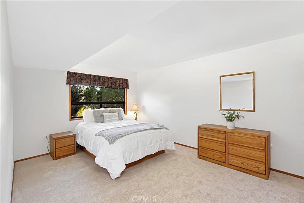 11879 Rocoso Road Lakeside, CA 92040 - Photo 18 of 25 a bedroom with a bed and a flat screen tv