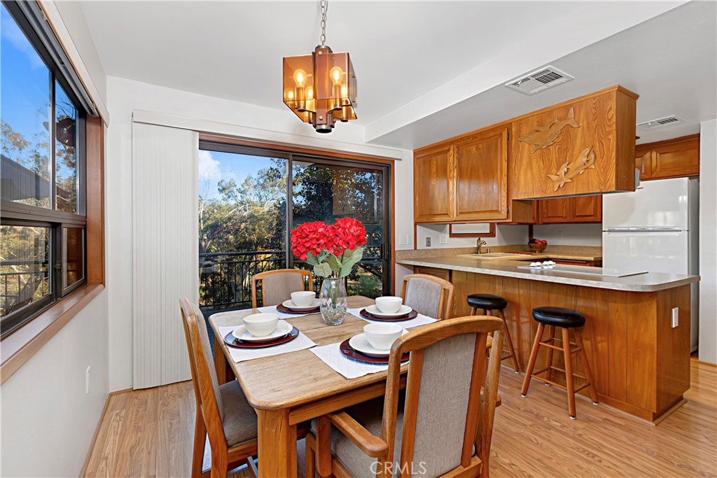 11879 Rocoso Road Lakeside, CA 92040 - Photo 10 of 25 a view of a dining room with furniture window and wooden floor