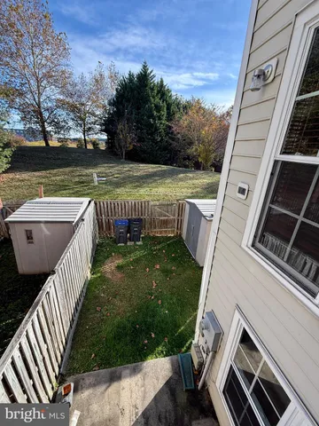 a view of a backyard with couches chair and wooden floor