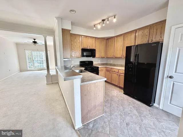 a kitchen with a refrigerator a stove top oven a sink and dishwasher