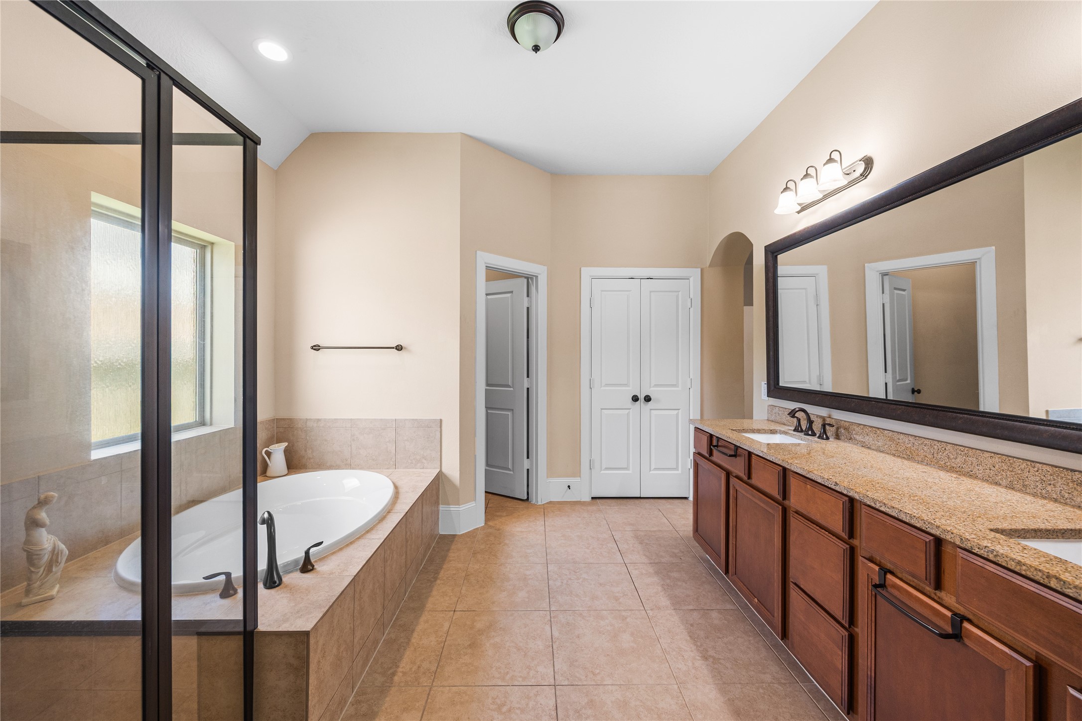 31311 Brighton Brook Lane Spring, TX 77386 - Photo 22 of 43 Spacious primary ensuite with a soaking tub, separate shower, and double sinks for added comfort and convenience.