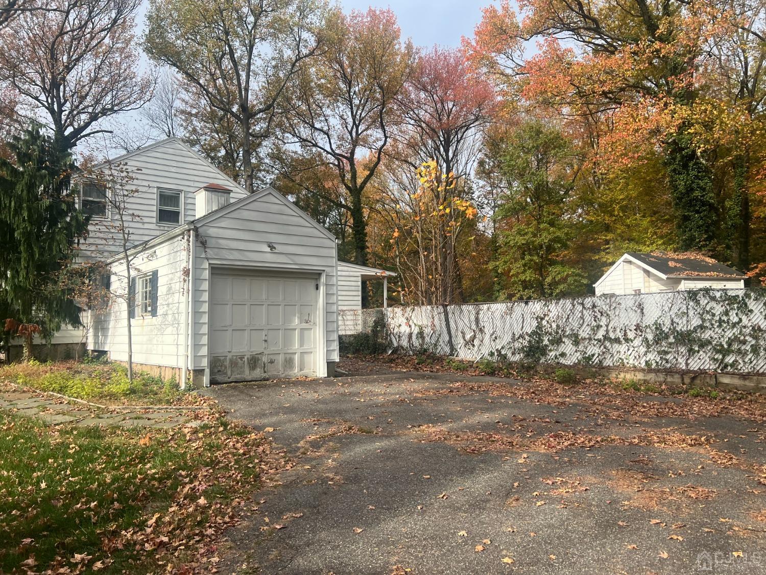 399 Middlesex Avenue Colonia, NJ 07067 - Photo 3 of 9 a front view of a house with a yard and garage