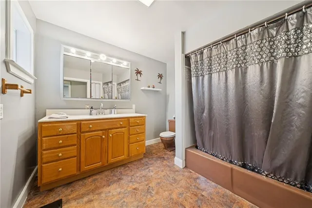 a view of a kitchen cabinets a sink and dishwasher wooden floor