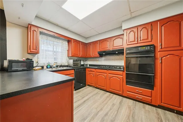 a kitchen with stainless steel appliances granite countertop wooden cabinets a sink and dishwasher