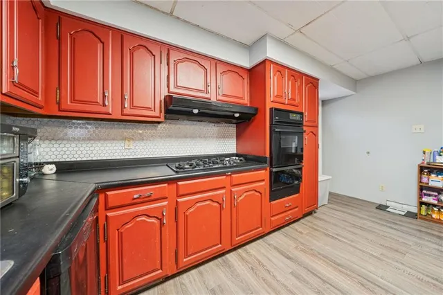 a kitchen with stainless steel appliances a refrigerator and a stove top oven