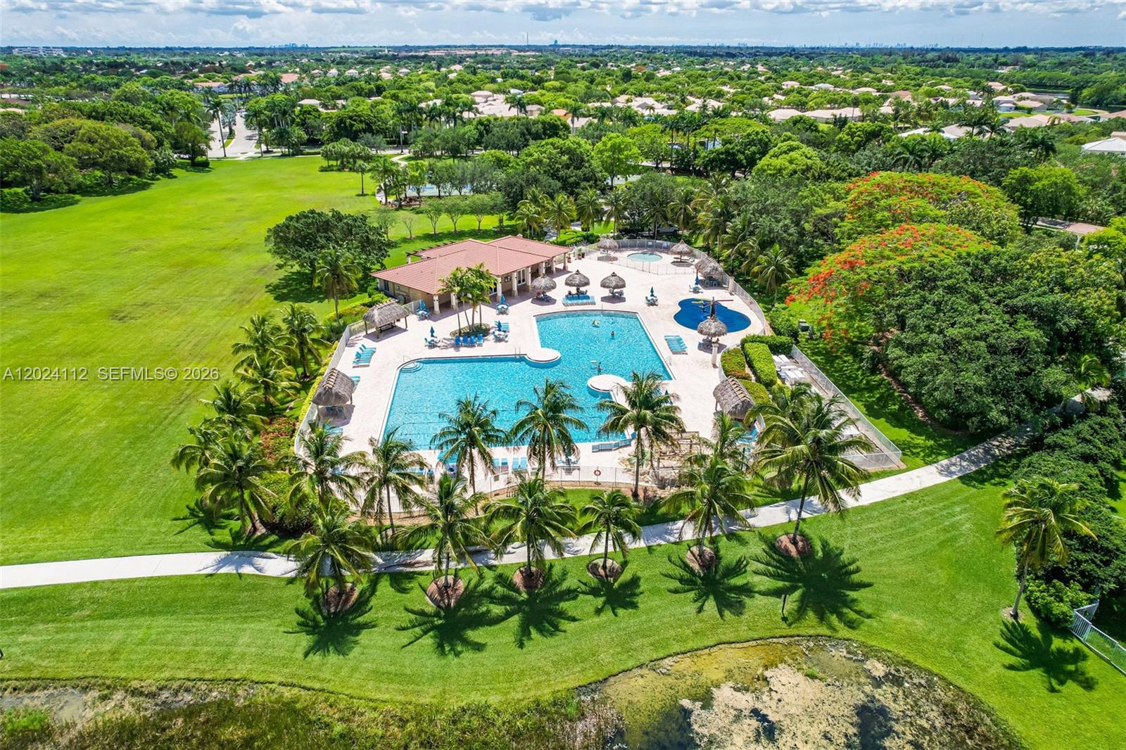 4366 Mahogany Ridge Drive Weston, FL 33331 - Photo 36 of 41 a view of a garden with a building in the background