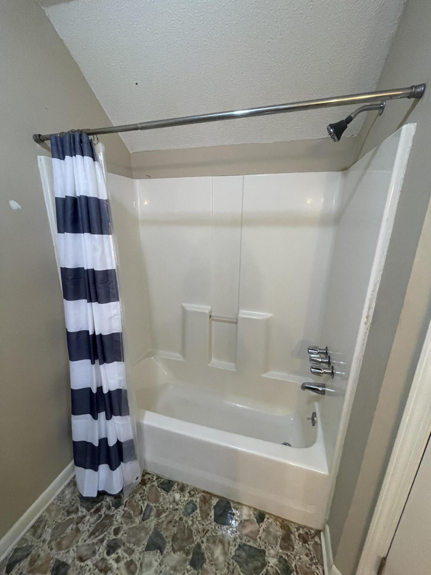 5341 Galiver Cutoff Baker, FL 32531 - Photo 11 of 13 a bathroom with a bathtub and a shower