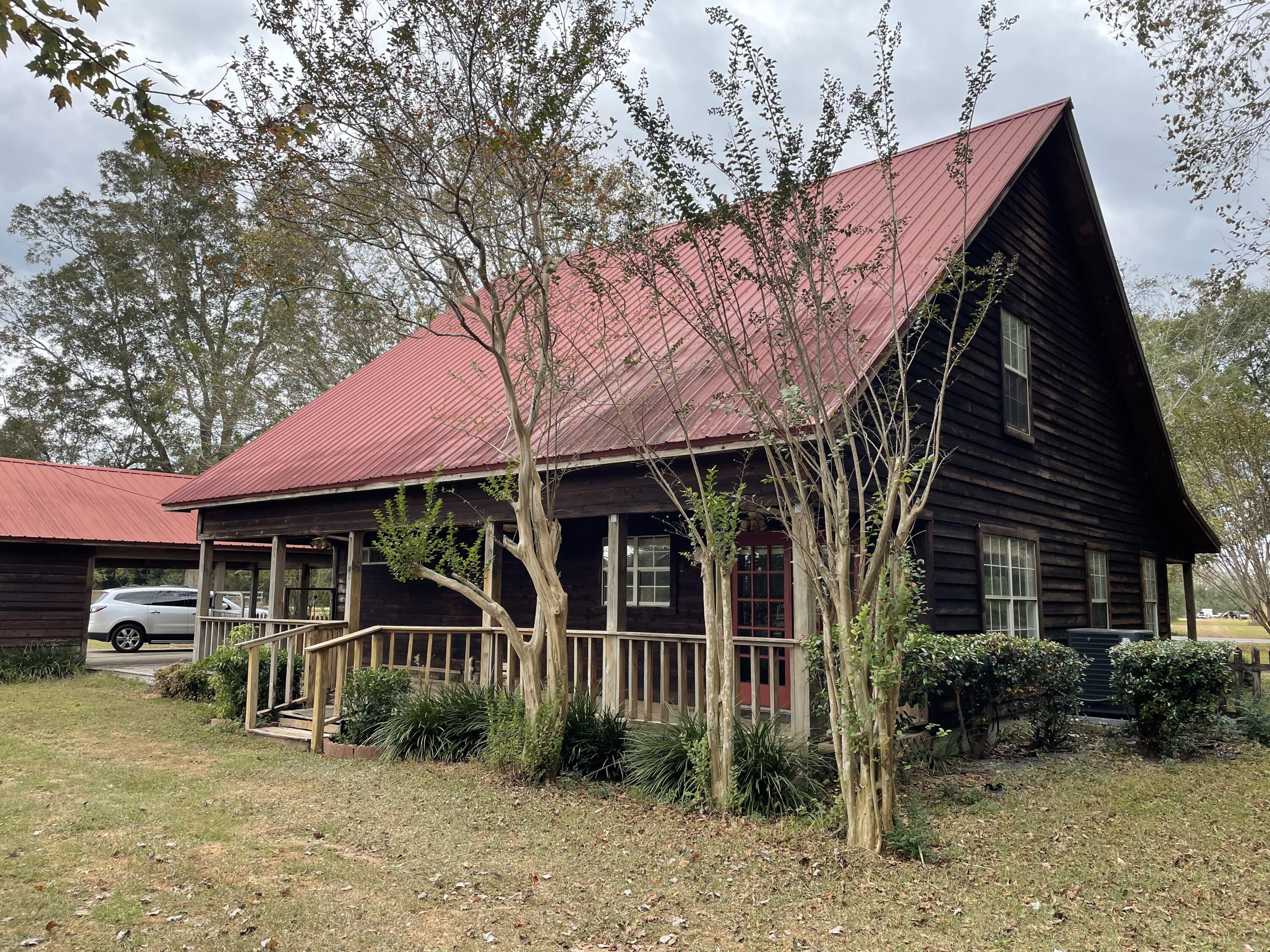 5341 Galiver Cutoff Baker, FL 32531 - Photo 2 of 13 a front view of a house with garden