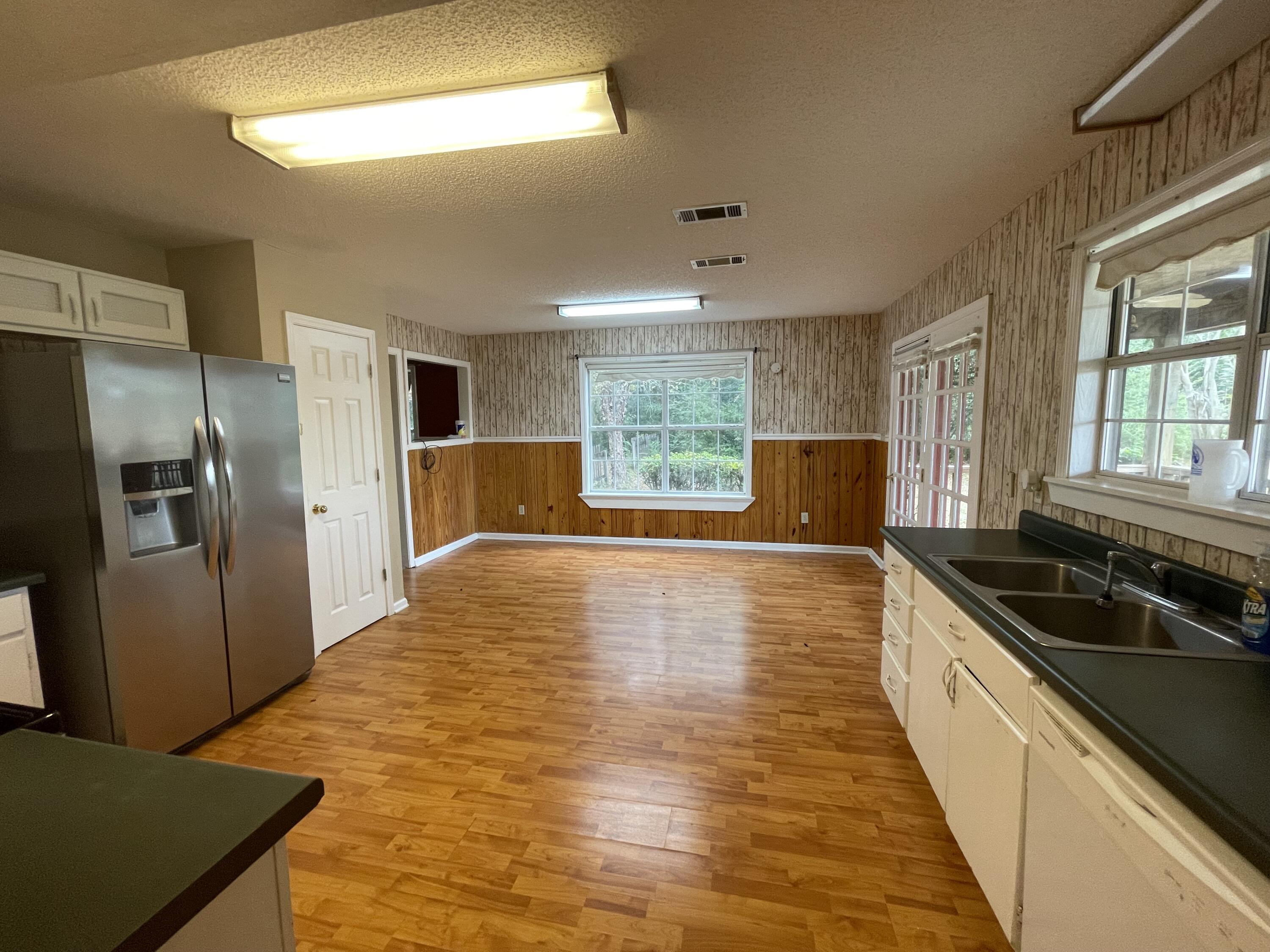 5341 Galiver Cutoff Baker, FL 32531 - Photo 4 of 13 a kitchen with stainless steel appliances granite countertop a sink and wooden cabinets