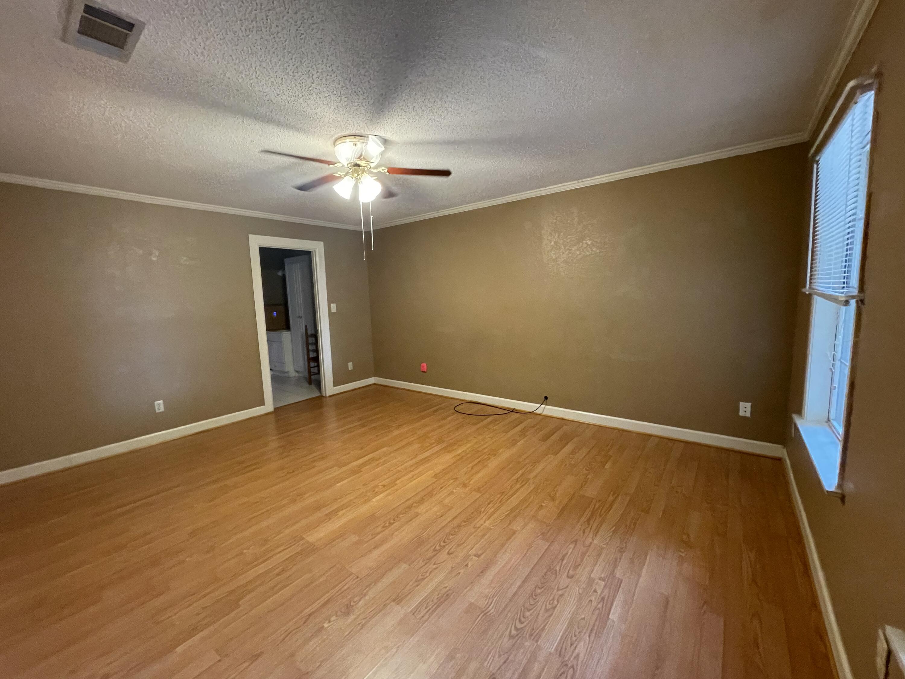 5341 Galiver Cutoff Baker, FL 32531 - Photo 5 of 13 a view of empty room with wooden floor and fan