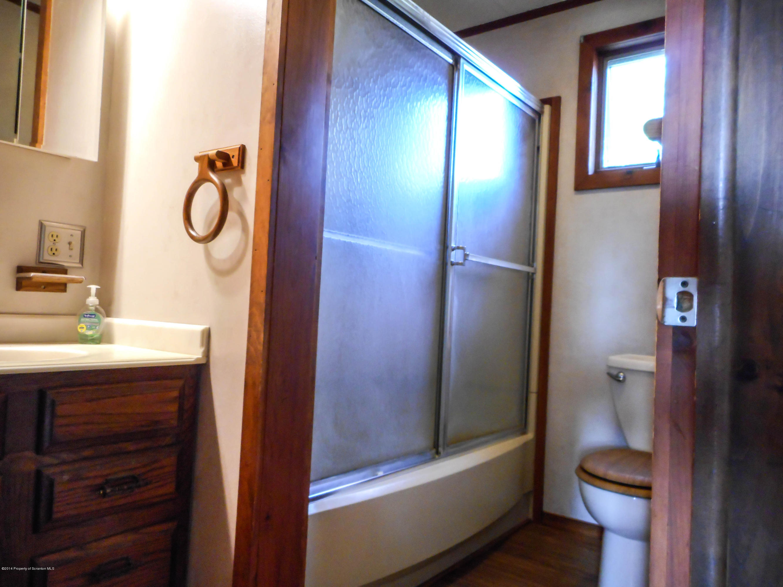 18806 Dimock To Nicholson Road Nicholson, PA 18446 - Photo 13 of 42 a bathroom with a granite countertop sink toilet and shower