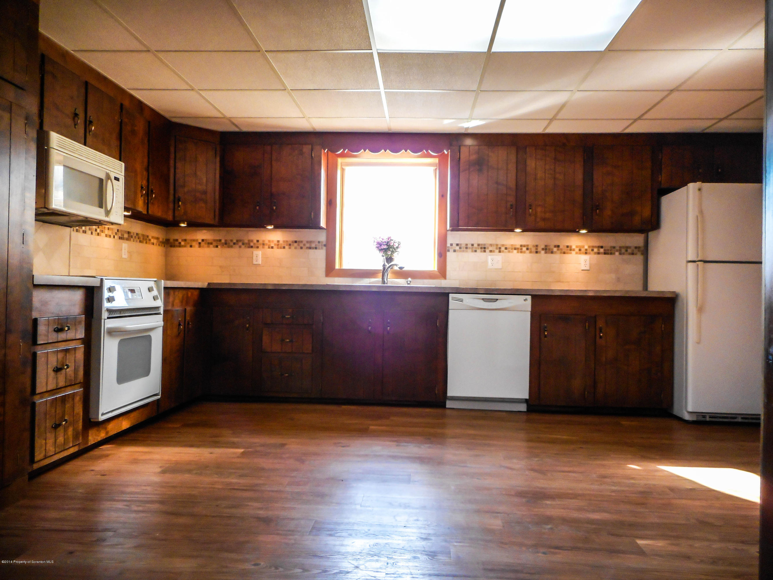 18806 Dimock To Nicholson Road Nicholson, PA 18446 - Photo 9 of 42 a kitchen with stainless steel appliances granite countertop a stove a sink and a refrigerator