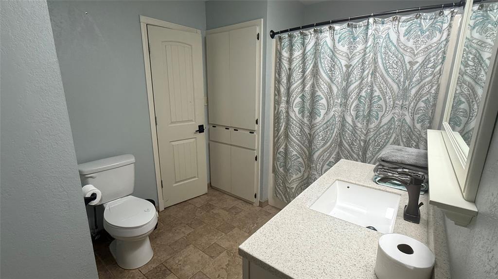1356 Kerry Lane Azle, TX 76020 - Photo 16 of 27 Bathroom featuring an integrated sink, broad countertop, and wood-finish flooring