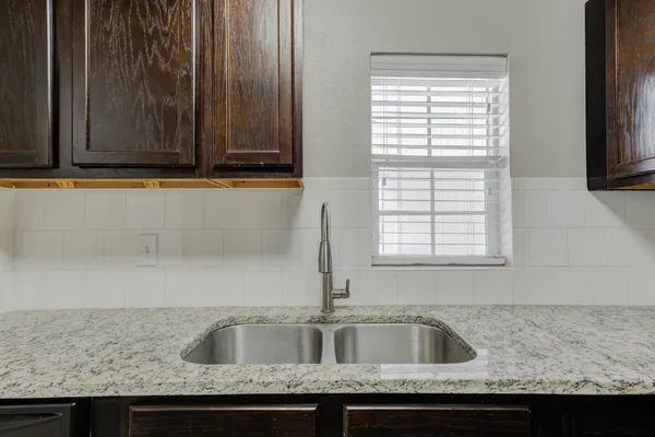 a kitchen with granite countertop a sink and a granite counter tops