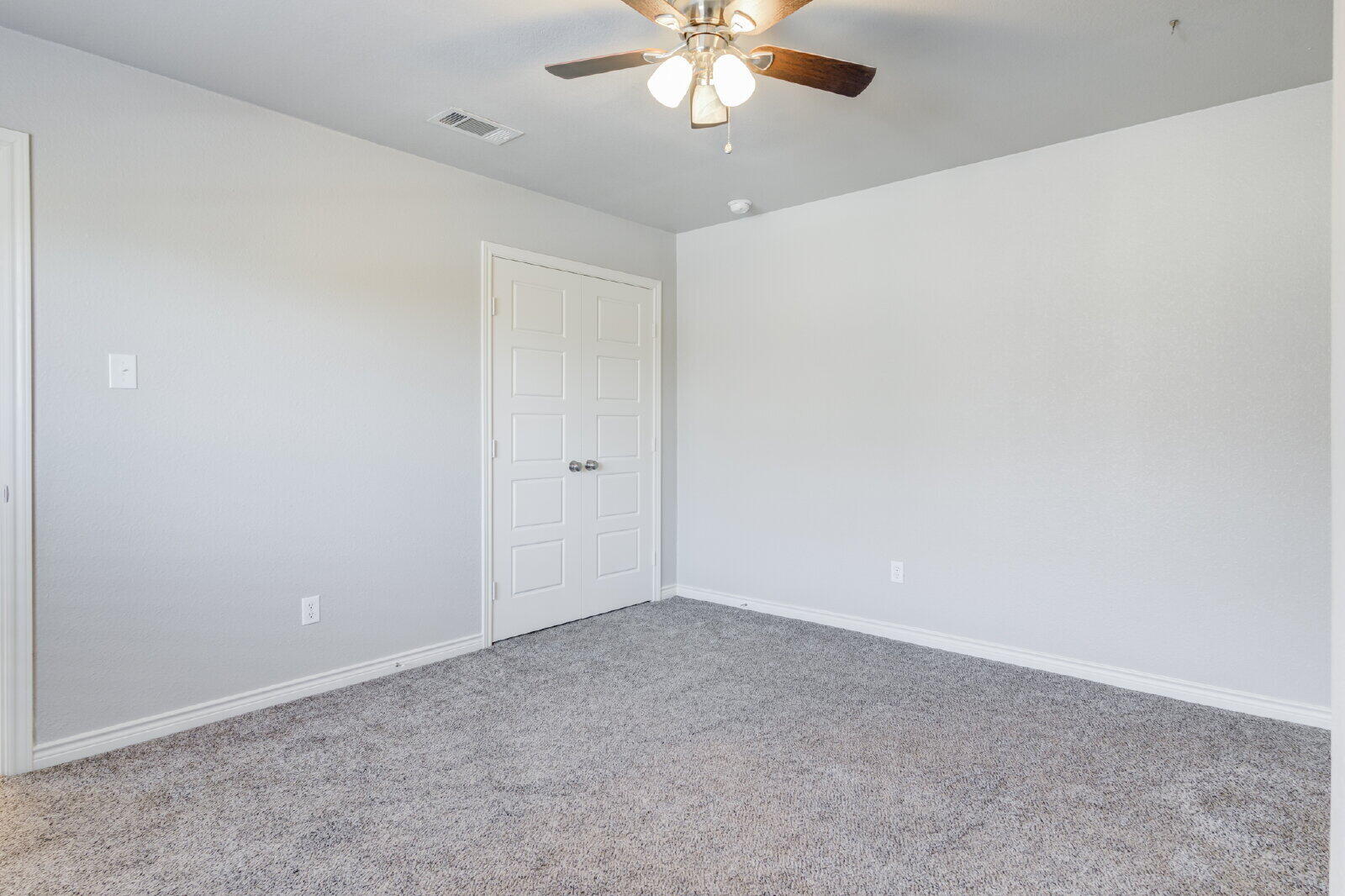 4320 52nd Street, Unit B Lubbock, TX 79413 - Photo 18 of 25 a view of an empty room with a chandelier fan