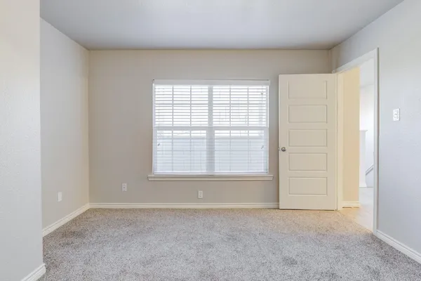 an empty room with a empty space and windows