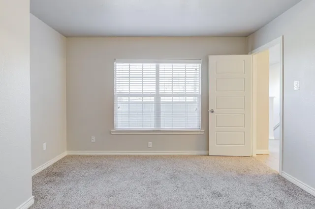 an empty room with a empty space and windows