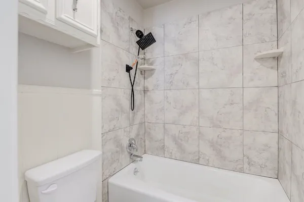 a bathroom with a bathtub and a shower