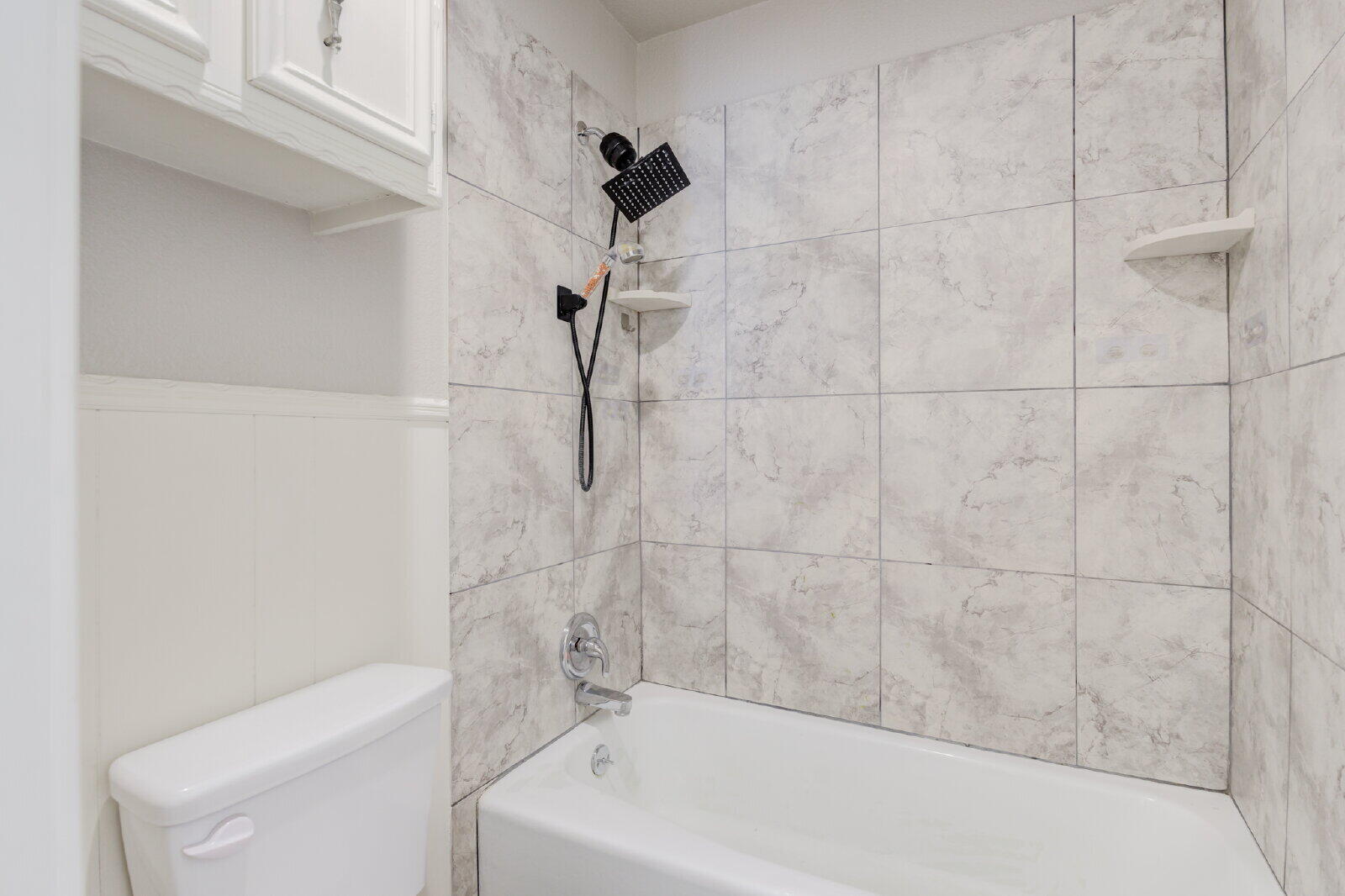 4320 52nd Street, Unit B Lubbock, TX 79413 - Photo 22 of 25 a bathroom with a bathtub and a shower