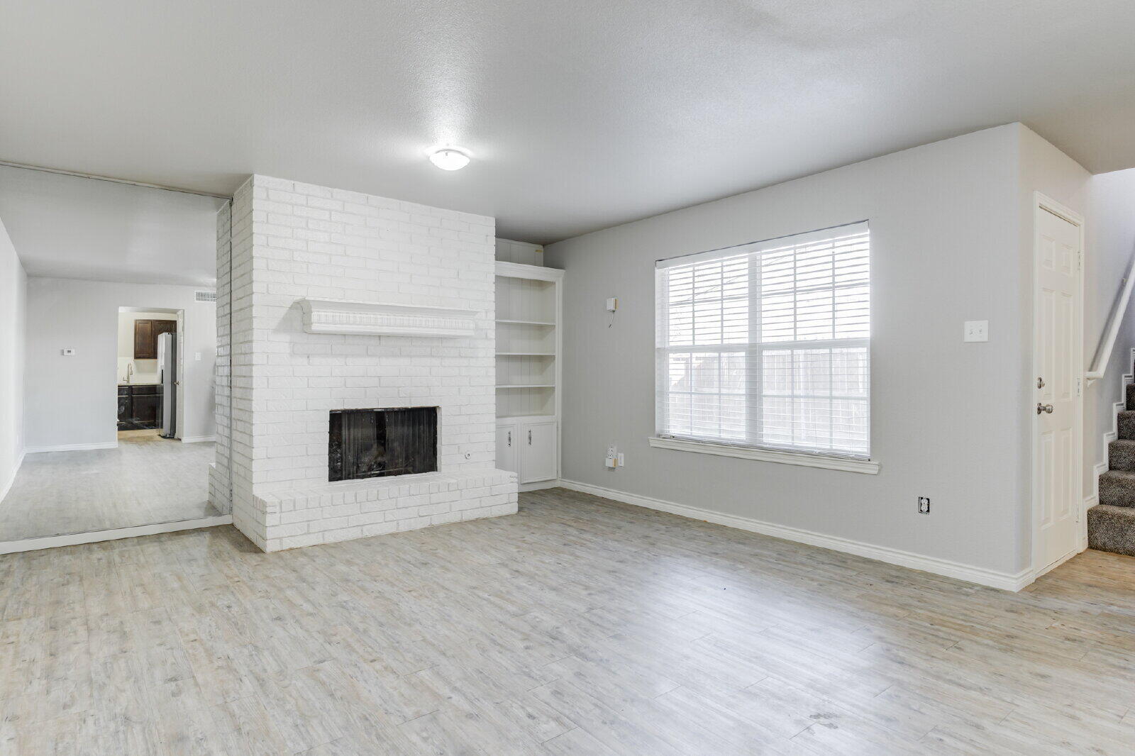 4320 52nd Street, Unit B Lubbock, TX 79413 - Photo 5 of 25 an empty room with windows and fireplace