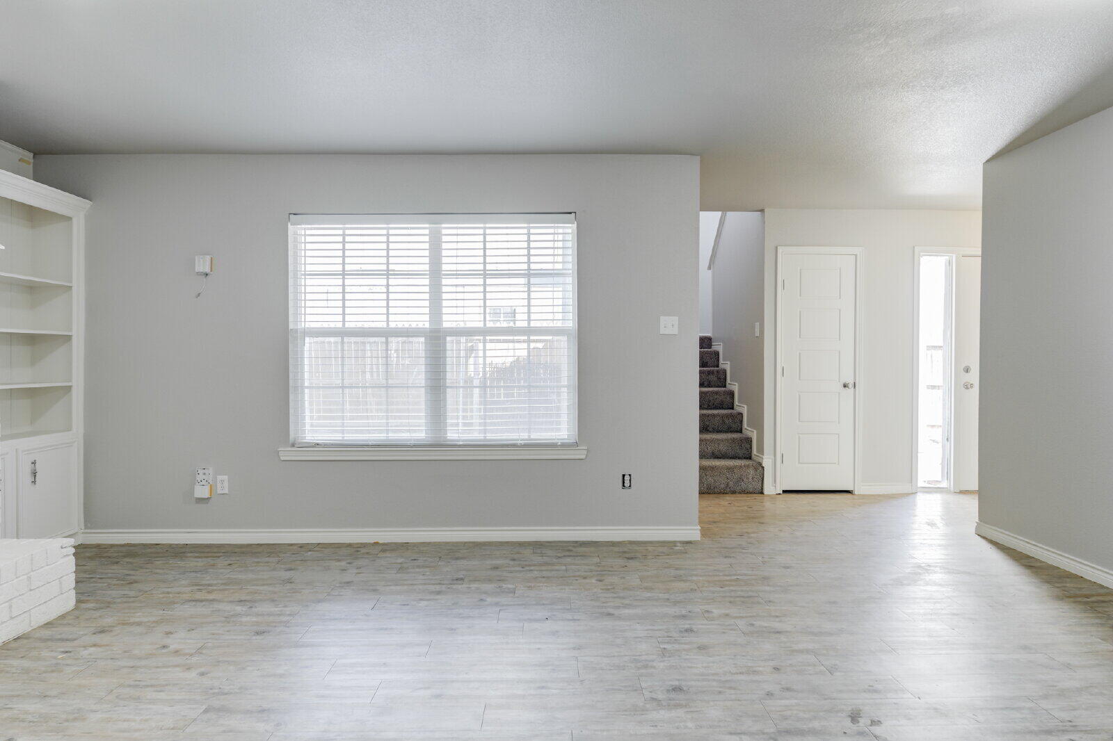 4320 52nd Street, Unit B Lubbock, TX 79413 - Photo 6 of 25 an empty room with wooden floor and windows