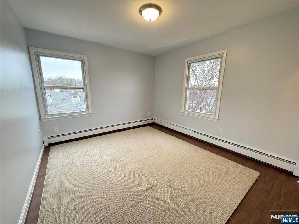 50 Buschmann Avenue Haledon, NJ 07508 - Photo 3 of 8 an empty room with windows