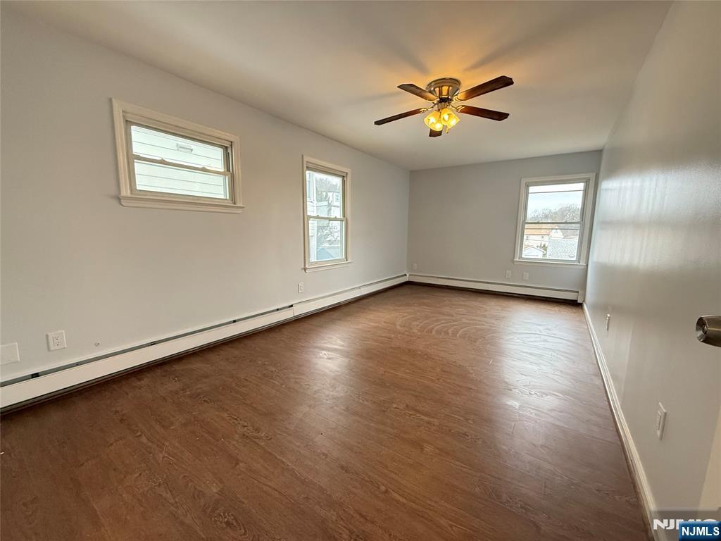 50 Buschmann Avenue Haledon, NJ 07508 - Photo 4 of 8 a view of empty room with wooden floor and fan