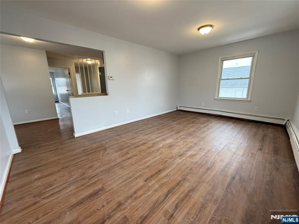 50 Buschmann Avenue Haledon, NJ 07508 - Photo 6 of 8 an empty room with wooden floor and windows