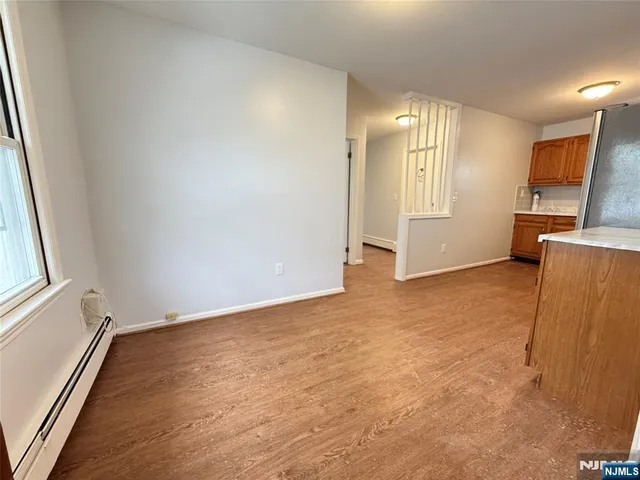 an empty room with a fireplace and windows